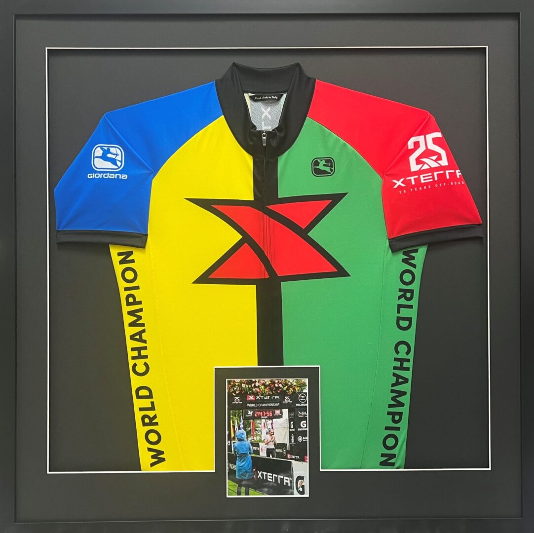 A framed jersey with a card in it.