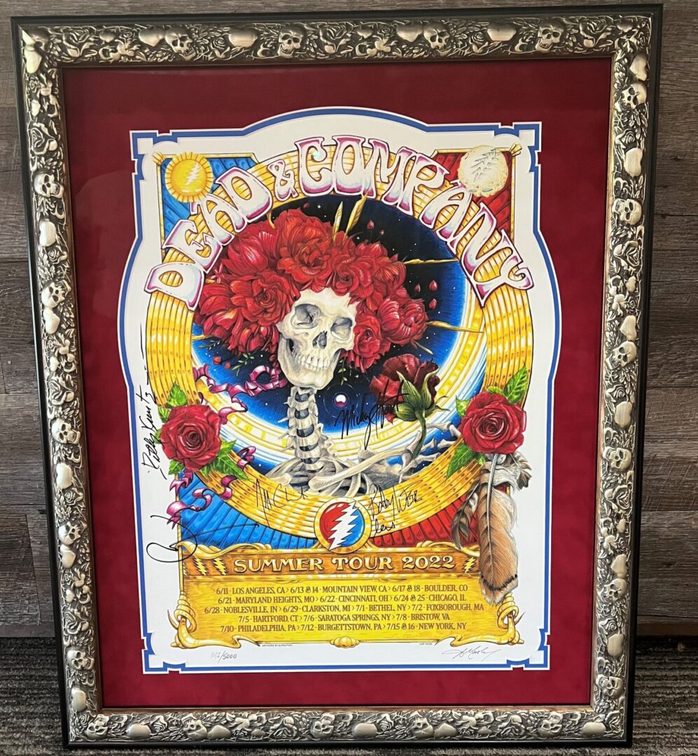 A framed poster of dia de los muertos with red flowers.