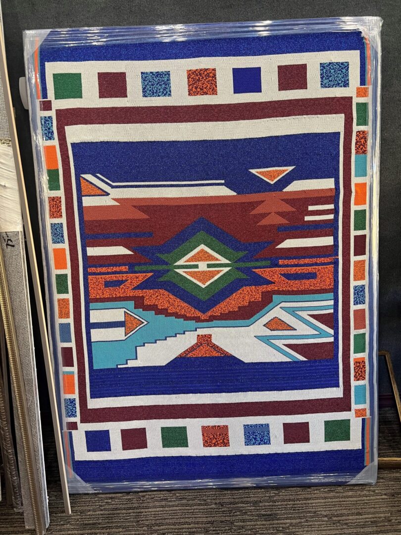 A quilt with an abstract design on it.